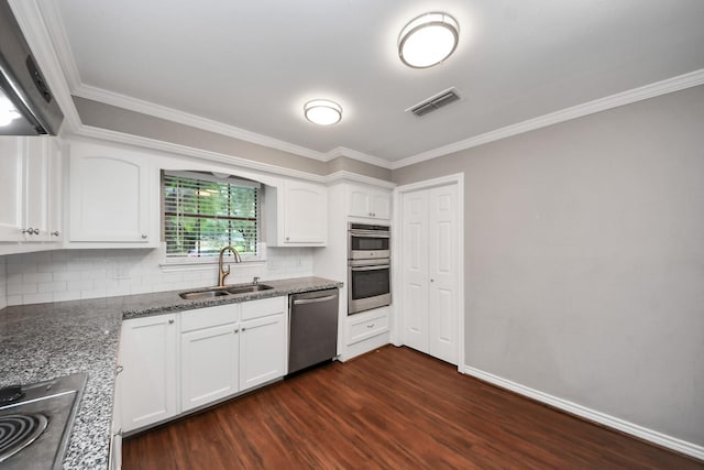 15510 Jersey Dr, Jersey Village, TX 77040 - kitchen with stainless steel appliances, dark wood-type flooring, crown molding, white cabinetry, and decorative backsplash