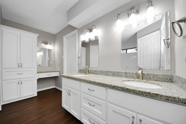 15510 Jersey Dr, Jersey Village, TX 77040 - bathroom featuring a sink, baseboards, double vanity, and wood finished floors