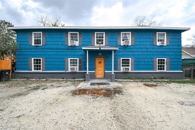 view of front of property featuring cooling unit and brick siding
