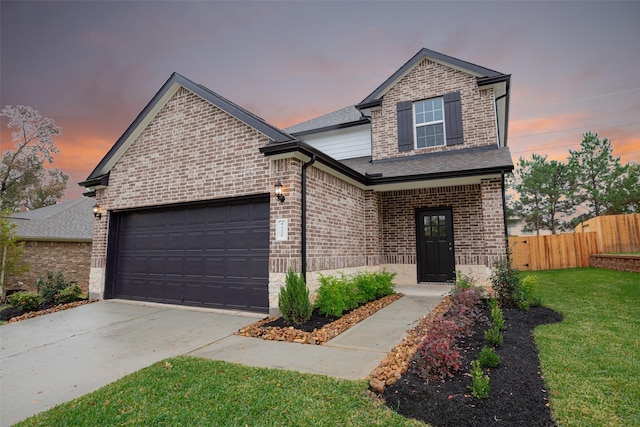 view of front of house featuring fence, concrete driveway, a garage, and brick siding
