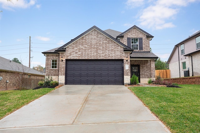 view of front of house with brick siding, a front lawn, fence, and driveway