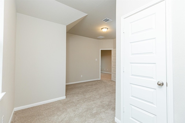 unfurnished room with baseboards, visible vents, and light colored carpet