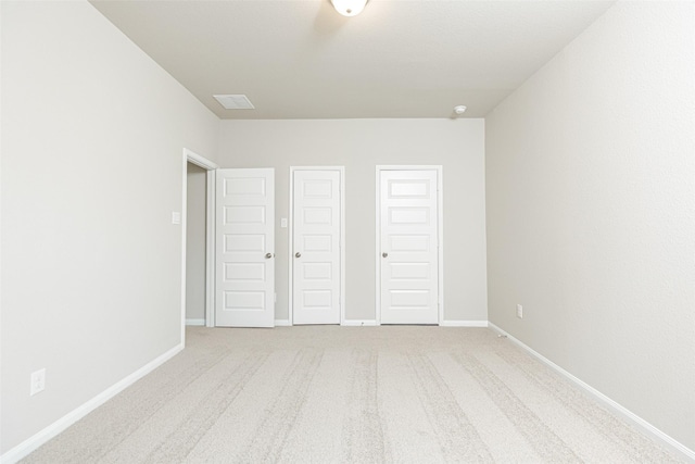 unfurnished bedroom featuring carpet floors, baseboards, and visible vents