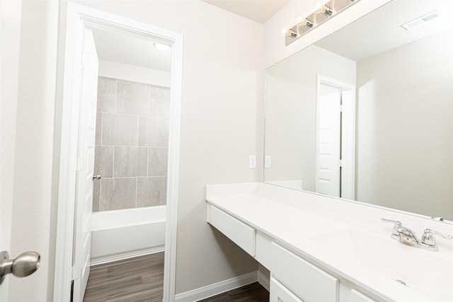 full bathroom featuring visible vents, vanity, shower / bathtub combination, wood finished floors, and baseboards