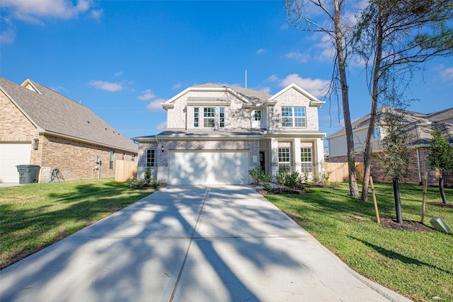 traditional home featuring a garage, fence, driveway, and a front yard