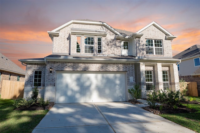 view of front of home featuring fence, an attached garage, concrete driveway, and brick siding