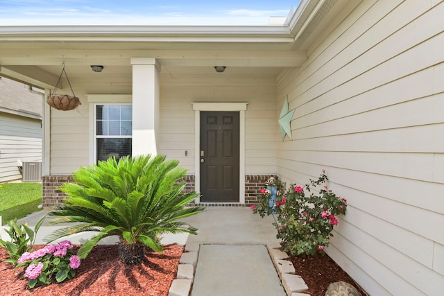 property entrance with a porch and central air condition unit