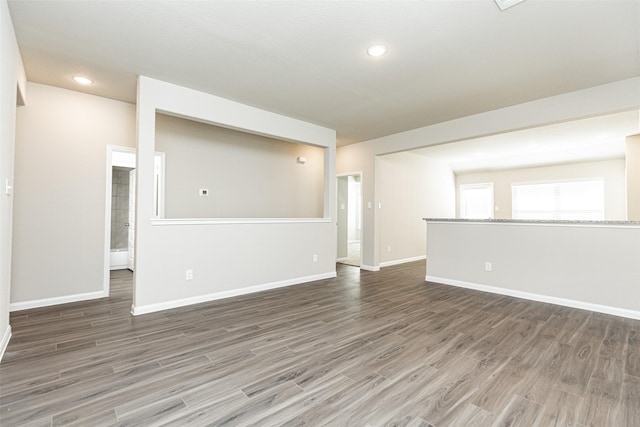 unfurnished room with recessed lighting, baseboards, and wood finished floors