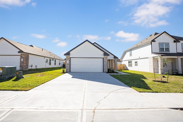 view of front of house with concrete driveway, fence, and a front lawn