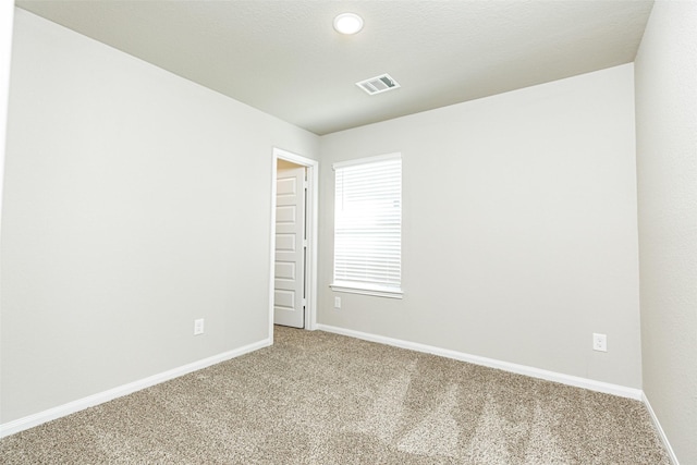 spare room with carpet flooring, recessed lighting, baseboards, and visible vents