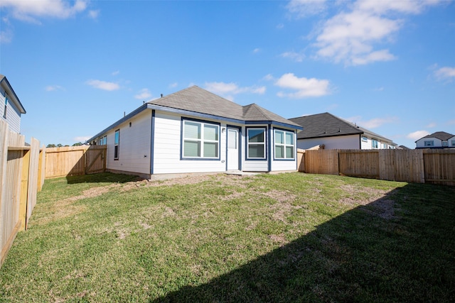 back of house featuring a fenced backyard and a yard
