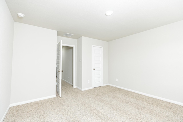 2897 Briggs Dr, Conroe, TX 77301 - unfurnished bedroom featuring light colored carpet, baseboards, and visible vents