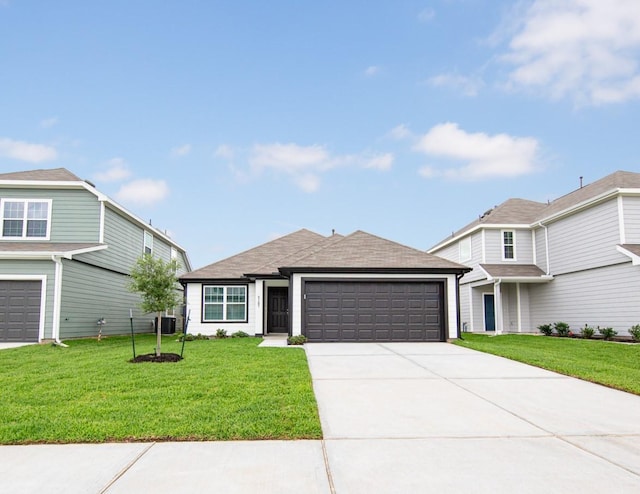 5107 Hector Gustavo Dr, Rosharon, TX 77583 - view of front facade featuring an attached garage, driveway, and a front lawn