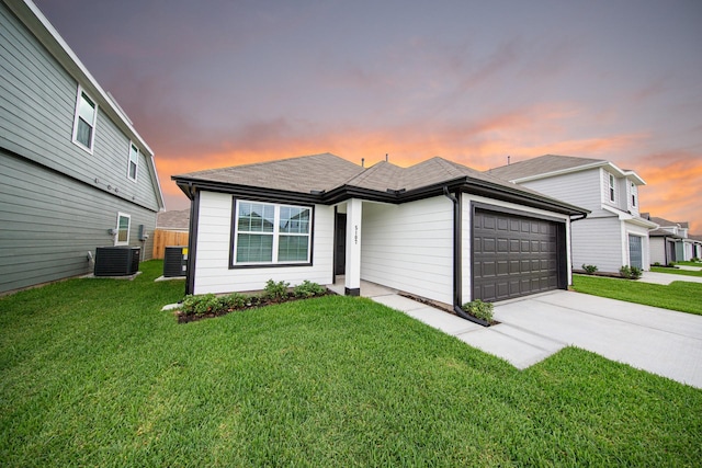 5107 Hector Gustavo Dr, Rosharon, TX 77583 - view of front of home with central AC, driveway, an attached garage, and a front yard
