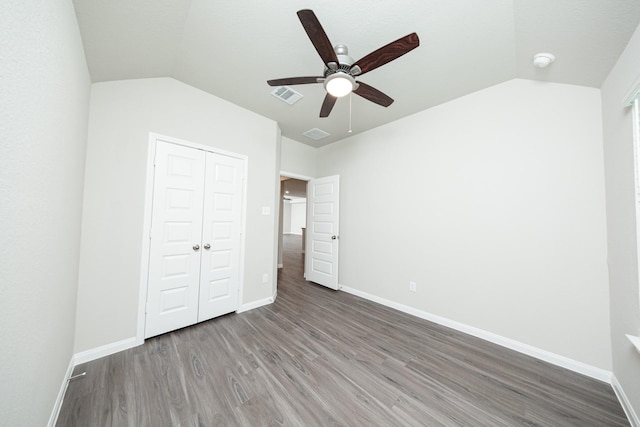 5107 Hector Gustavo Dr, Rosharon, TX 77583 - unfurnished bedroom with a closet, vaulted ceiling, wood finished floors, and baseboards