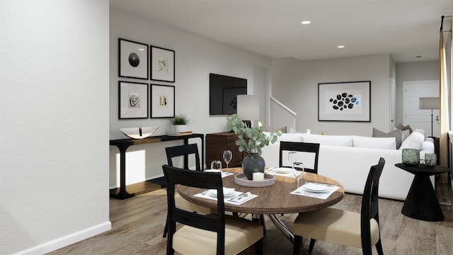 dining area with light wood-style floors, baseboards, and recessed lighting