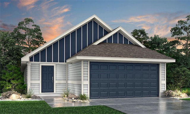 view of front of house featuring a garage, board and batten siding, roof with shingles, and concrete driveway