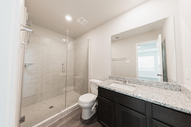 5114 Hector Gustavo Dr, Rosharon, TX 77583 - bathroom featuring a stall shower, toilet, visible vents, vanity, and wood finished floors