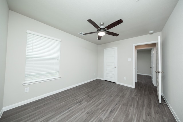 5114 Hector Gustavo Dr, Rosharon, TX 77583 - unfurnished bedroom featuring a ceiling fan, visible vents, dark wood-style flooring, and baseboards
