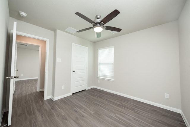5114 Hector Gustavo Dr, Rosharon, TX 77583 - unfurnished bedroom featuring baseboards, dark wood-style flooring, visible vents, and a ceiling fan