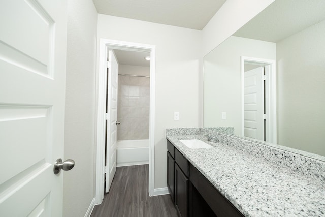 5114 Hector Gustavo Dr, Rosharon, TX 77583 - bathroom with baseboards, shower / bathtub combination, vanity, and wood finished floors
