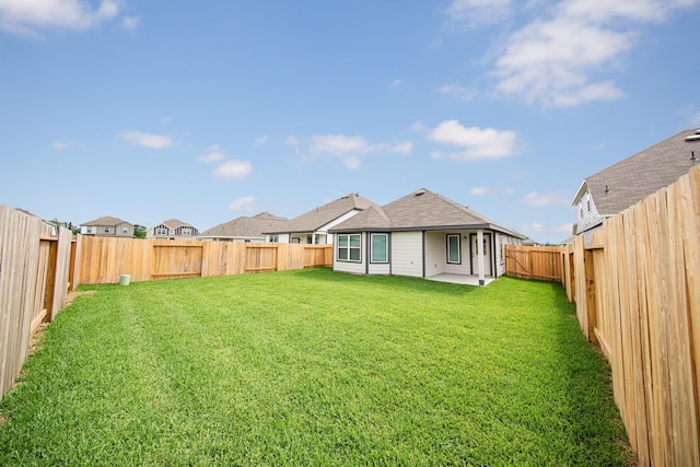 5114 Hector Gustavo Dr, Rosharon, TX 77583 - back of property featuring a yard, a residential view, a fenced backyard, and a patio