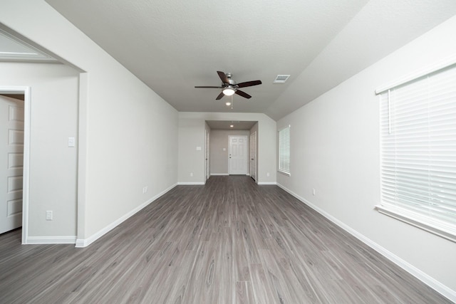 5114 Hector Gustavo Dr, Rosharon, TX 77583 - unfurnished living room with a ceiling fan, baseboards, a wealth of natural light, visible vents, and wood finished floors