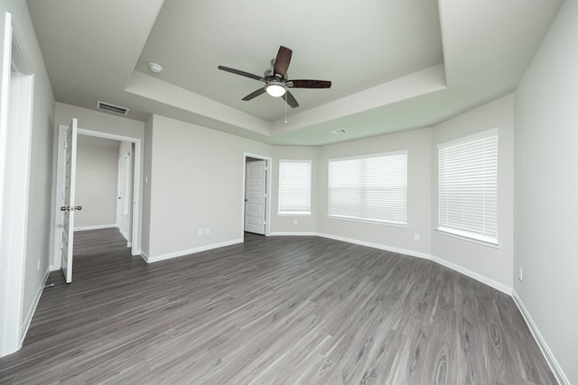 5114 Hector Gustavo Dr, Rosharon, TX 77583 - unfurnished bedroom featuring a tray ceiling, visible vents, wood finished floors, and baseboards