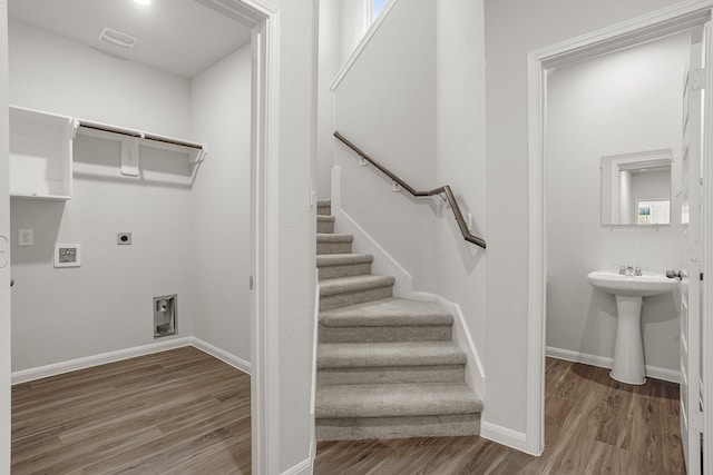 13617 Goldeye Dr, Conroe, TX 77384 - washroom featuring laundry area, hookup for a washing machine, baseboards, electric dryer hookup, and wood finished floors