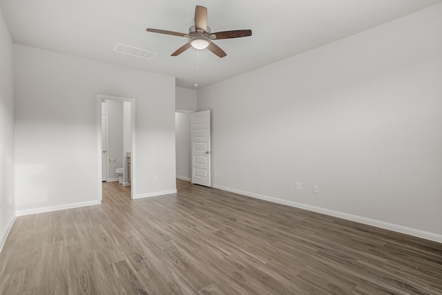 13617 Goldeye Dr, Conroe, TX 77384 - unfurnished bedroom featuring ceiling fan, ensuite bath, baseboards, wood finished floors, and visible vents