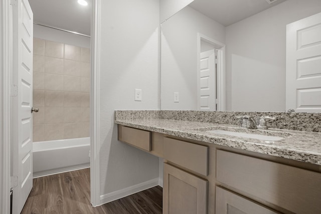 13617 Goldeye Dr, Conroe, TX 77384 - bathroom with baseboards, vanity, shower / bathtub combination, and wood finished floors