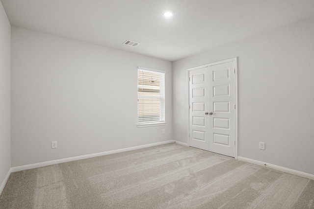 13617 Goldeye Dr, Conroe, TX 77384 - unfurnished bedroom with baseboards, visible vents, and light carpet