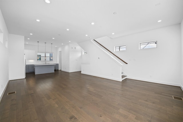 unfurnished living room featuring recessed lighting, visible vents, and dark wood finished floors