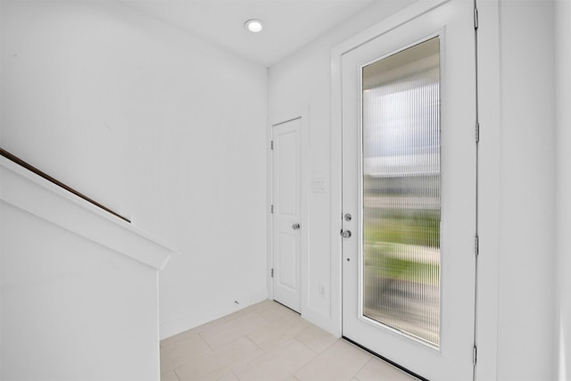 doorway to outside with light tile patterned floors