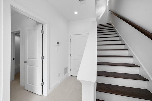 stairway featuring recessed lighting, baseboards, visible vents, and tile patterned flooring
