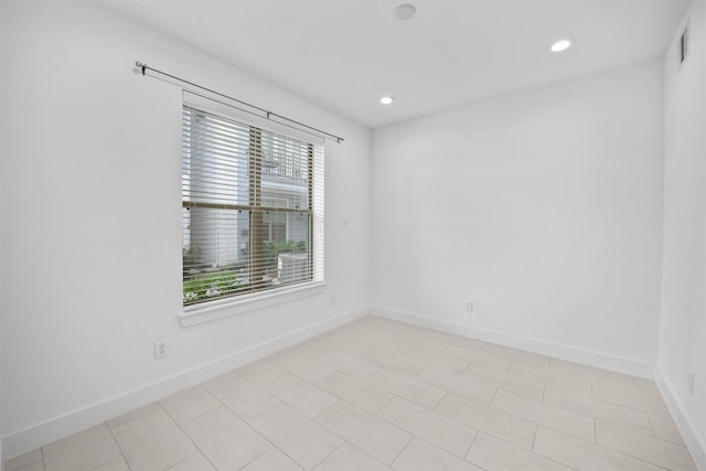 empty room featuring visible vents, recessed lighting, baseboards, and a wealth of natural light