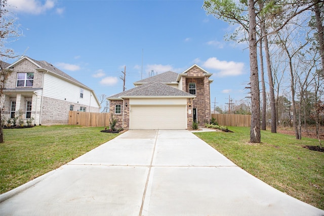 traditional-style house with fence, roof with shingles, an attached garage, a front yard, and concrete driveway