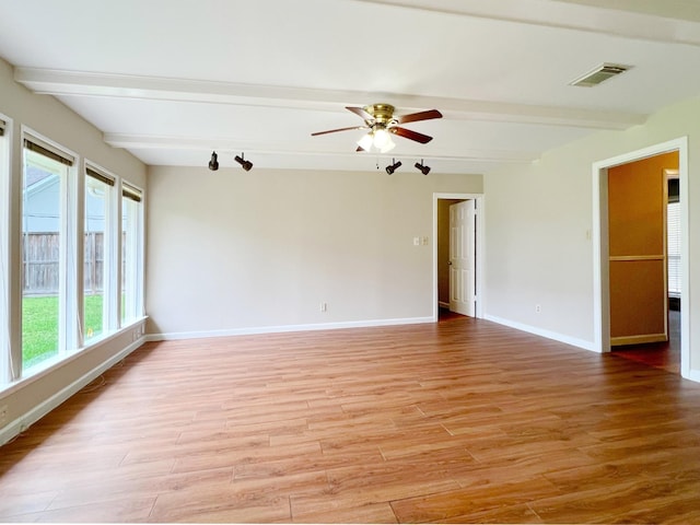 unfurnished room featuring ceiling fan, visible vents, beam ceiling, and light wood-style floors