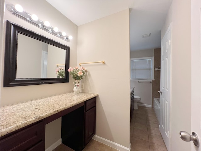 bathroom featuring toilet, tile patterned floors, baseboards, and vanity