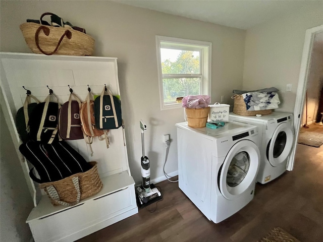 laundry room with independent washer and dryer, dark wood-style flooring, and laundry area