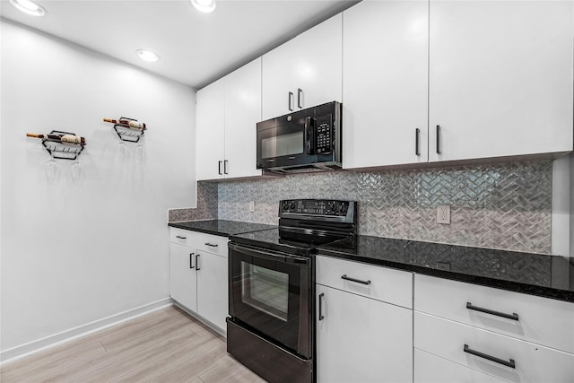 kitchen featuring baseboards, white cabinets, tasteful backsplash, light wood-style flooring, and black appliances