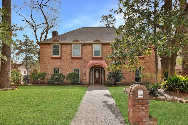 5503 Pebble Springs Dr, Houston, TX 77066 - view of front of house with a chimney, brick siding, and a shingled roof