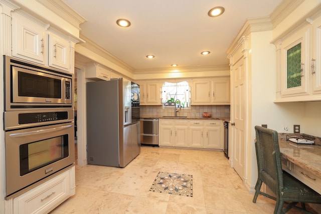 5503 Pebble Springs Dr, Houston, TX 77066 - kitchen featuring appliances with stainless steel finishes, a sink, crown molding, decorative backsplash, and recessed lighting