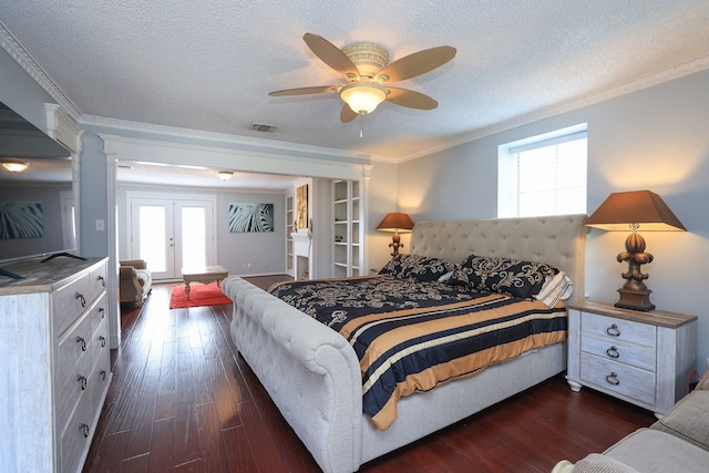 5503 Pebble Springs Dr, Houston, TX 77066 - bedroom featuring multiple windows, ornamental molding, dark wood-style floors, a textured ceiling, and french doors