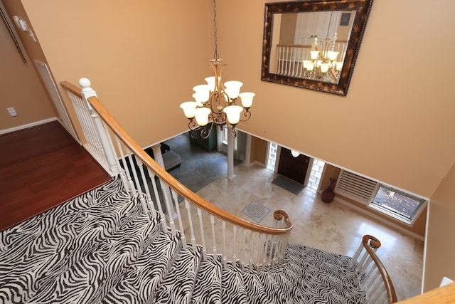 5503 Pebble Springs Dr, Houston, TX 77066 - stairway featuring a chandelier, a towering ceiling, and baseboards