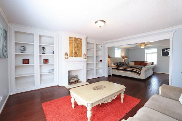 5503 Pebble Springs Dr, Houston, TX 77066 - bedroom with wood finished floors, a fireplace with raised hearth, ornamental molding, baseboards, and a ceiling fan