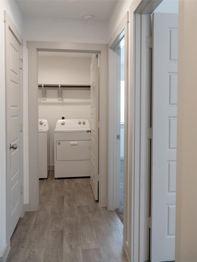711 Boer Plains Dr, Rosharon, TX 77583 - corridor with washer and clothes dryer and wood finished floors