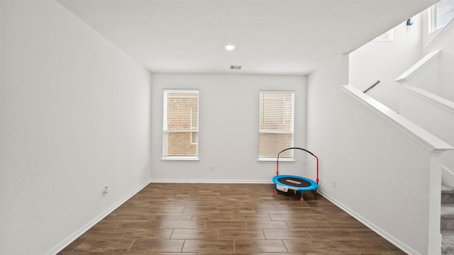 6630 Elks Trce, Richmond, TX 77406 - unfurnished room featuring baseboards, wood tiled floor, and stairs