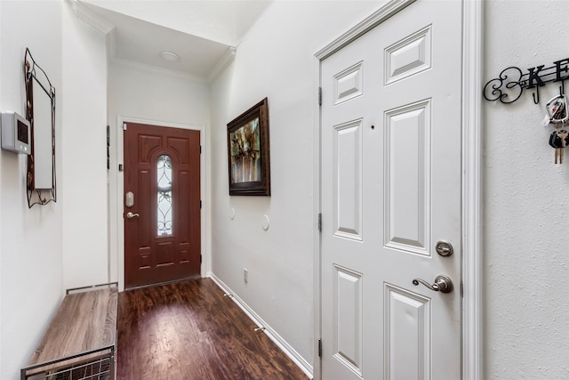 entrance foyer featuring crown molding, wood finished floors, and baseboards