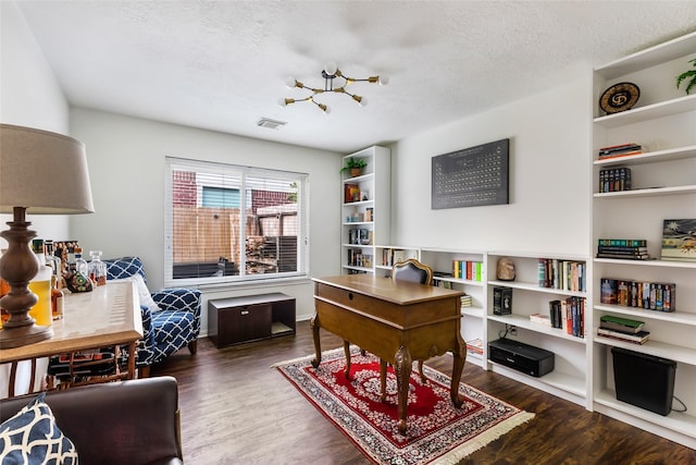 home office featuring wood finished floors and a textured ceiling